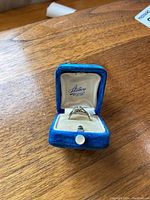 Ring in vintage blue velvet box showing front profile and setting details