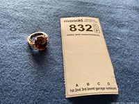 Ring and lot tag on blue fabric