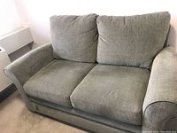 Front angle view of the sage grey La-Z-Boy loveseat showing two seat cushions and two large back cushions