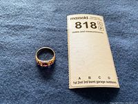 Ring on blue background next to MaxSold lot tag