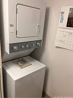 Full view of stacked washer (bottom) and dryer (top) in white finish