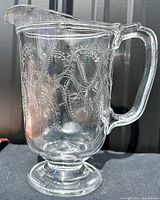 Front angle view showing the barley pattern and handle detail on the clear glass pitcher.