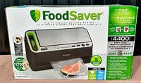 Front of the FoodSaver 4400 vacuum sealer box showing product image, branding, and benefits.