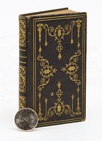 Front and back view of the small leather bound New Testament Bible showing intricate gilt decorations on cover.