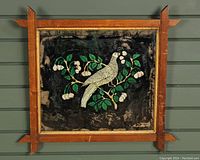 Frontal view of 19th century reverse painted foil bird artwork in wooden frame showing the white bird perched on leafy branch with white berries.