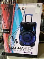 Box showing front side with speaker image, Atalax branding, Magna model name, 3000W power, 15 inch woofer, wireless speaker, TWS system logo, included microphone, and remote control.