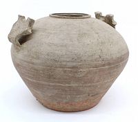 Oblique view of entire vessel showing overall form, grey slip surface and foot.