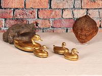 Overview photo showing the carved wooden frog, carved coconut head, and six gold-painted animal trinket boxes.
