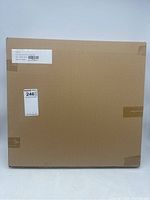 Closed brown cardboard box with label showing product and SKU details.