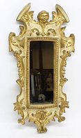 Full front view of the ornate gilt mirror