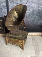 Close-up of miniature metallic Victorola with patina finish and horn detail
