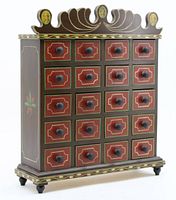 Three-quarter front view showing overall design, painted pattern on drawers and crest