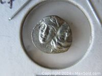 Close-up of obverse side showing two youthful heads facing right