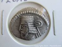 Obverse side of the Parthian drachm coin showing profile portrait with headdress