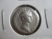Obverse side of the ancient silver Roman denarius coin showing the right-facing profile of Emperor Nerva wearing a laurel wreath with Latin inscriptions around.