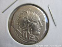 Obverse image of coin showing portrait of Roma wearing helmet.