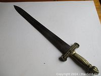 Full view of sword on white background showing straight blade and hilt.