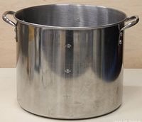 Front view of large stainless steel soup or chili pot showing two handles and interior volume markings.