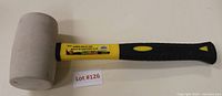 Front view of 24 oz rubber mallet showing white rubber head and yellow/black handle with grip