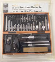 Photo of the 35 piece precision knife set in original packaging showing various knives and blades in an orange plastic case.