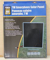 Front view of the 7W amorphous solar panel in its original packaging showing product information and branding.