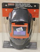 Front view of the welding helmet in packaging, showing the Shop Iron branding and fixed shade label.