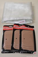 Three unopened packages of Bondo spreading tools arranged side by side, each package contains one plastic beige spreading tool for auto body filler application.