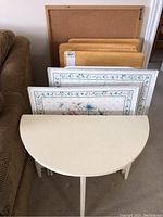 All tables and cork board arranged upright showing front surfaces and sizes relative to each other.