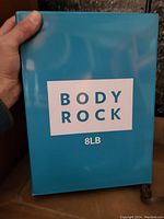 Photo of blue box showing 'BODY ROCK 8LB' text on front.