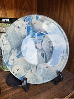 Collector plate displaying Arctic animals including polar bear, reindeer, rabbit, seal, and wolf in gray and white tones against a blue background.