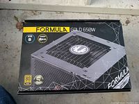 Box of Formula Gold 650W power supply unit showing branding, certification, and model details