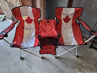 Front view of the connected folding 2 person chair with Canadian flag design and center console cup holder under armrests.