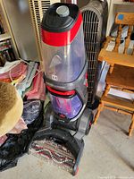 Hoover Power Scrub Deluxe upright carpet washer vacuum with visible brush roller and clear cleaning tanks.