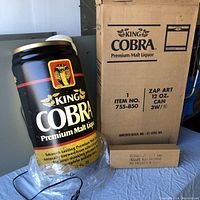 Photo of the King Cobra Premium Malt Liquor light-up sign with original box showing branding and item number.
