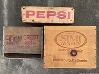 Top view of three wooden boxes showing Pepsi, Cream Crest, and Simi Winery logos and text