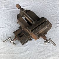 Overall angled view showing the vise body with its screw mechanism and base plate with handles