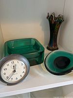 Westclox Baby Ben clock with square green glass dish, oval green glass dish, and carnival glass vase together