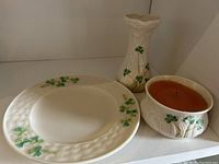 Photo showing the small plate, bud vase, and candle holder together with shamrock decoration