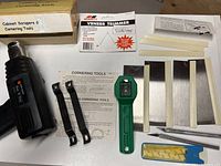 Photo showing full set of tools including Black & Decker heat tool, cornering tools, veneer trimmer blades, cabinet scraper blades, and Olfa cutters.