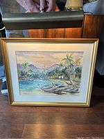 View of the adjustable brass picture light attached above the framed painting.