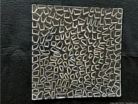 Top-down image of the crystal plate showing its geometric mosaic pattern.