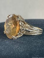 Side view showing filigree shoulders and twisted wire scroll motifs