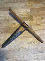 Full view of antique key hole drill showing wooden handle and metal drill blade with triangular cutout