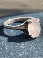 Side angle showing the silver band and iridescent stone.