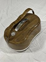 Closed food flask with wood grain finish, silver latch, and handle