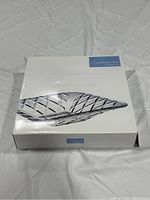 Closed box showing image of Mikasa Celebrations cut glass platter with blue label on top right corner.