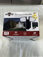 Box front showing the product image, brand Night Shield, features like LED, motion sensor, 500 lumens, solar powered, and measurements 9x8.