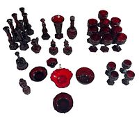 Full set of 40 pieces arranged showing a variety of goblets, bottles, bowls, and a pitcher in ruby red glass.