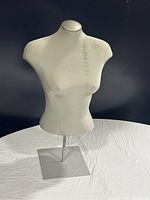 Front view of vintage female half dress mannequin on metal base