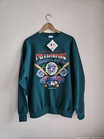 Full view of teal 1993 Toronto Blue Jays World Series Champions sweatshirt on hanger, new with tags.